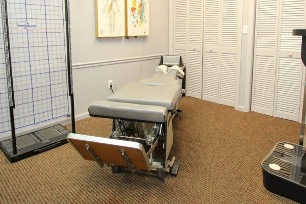 Medical exam room with patient table and spine model