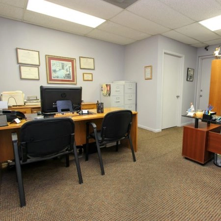 Office workspace with computer and chairs in professional setting Office desk with computer and chairs