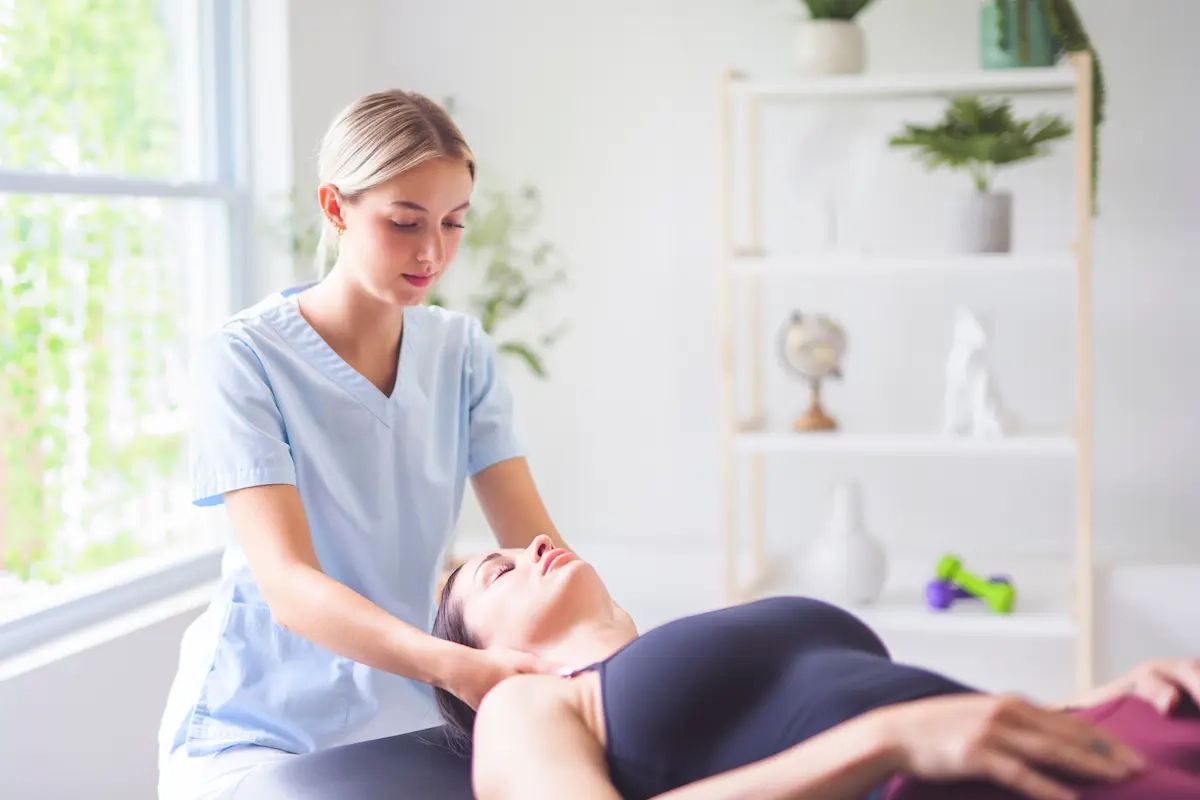 Therapist giving shoulder massage to woman